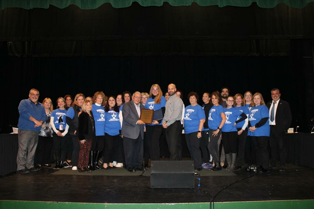 GO WIZARDS: The faculty and staff of Woodridge Elementary gather with Cranston School Committee members to celebrate Blue Ribbon recognition.